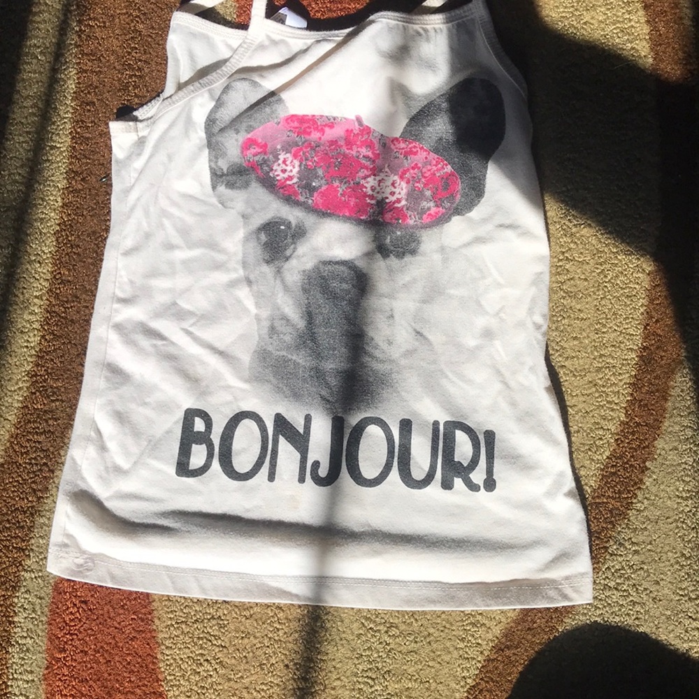 Creme colored top that says bonjour on the front